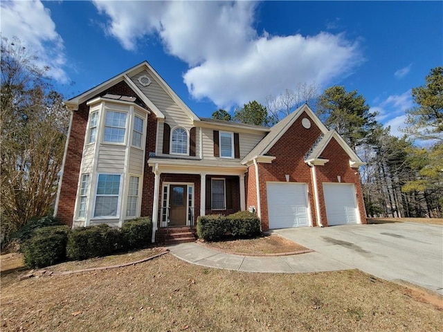 view of front of home featuring driveway, brick siding, and a garage