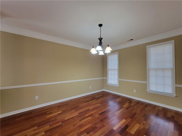 unfurnished room with a chandelier, wood finished floors, baseboards, and ornamental molding