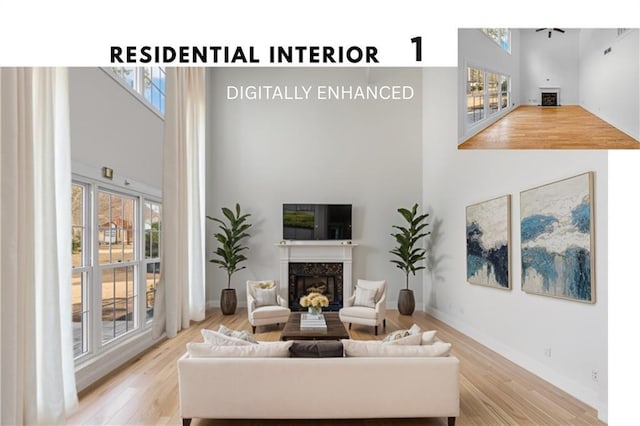 4120 Lakeside Blvd, Monroe, GA 30655 - living area featuring a premium fireplace, a towering ceiling, wood finished floors, and baseboards