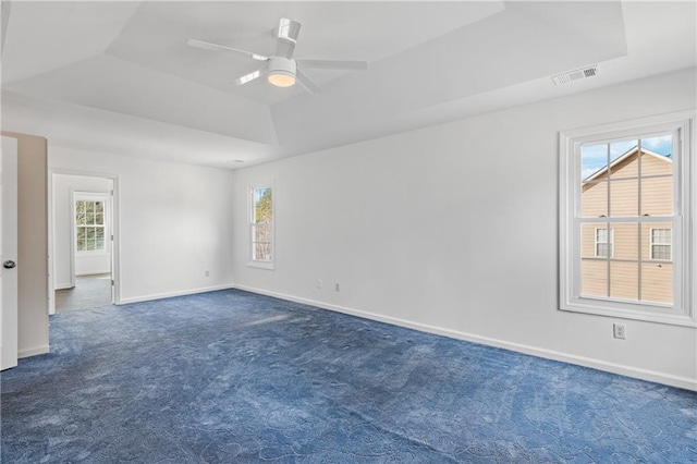 4120 Lakeside Blvd, Monroe, GA 30655 - empty room featuring a raised ceiling, dark carpet, plenty of natural light, and a ceiling fan