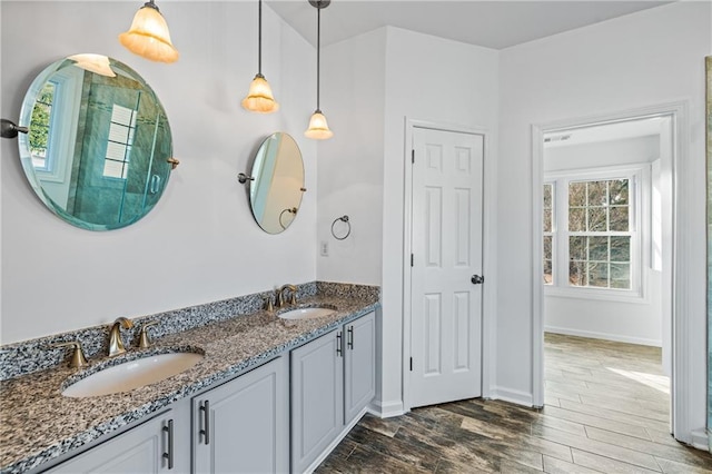 4120 Lakeside Blvd, Monroe, GA 30655 - bathroom featuring wood finished floors, double vanity, and baseboards