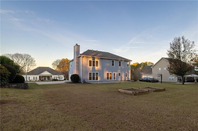 4120 Lakeside Blvd, Monroe, GA 30655 - rear view of property with a chimney and a lawn