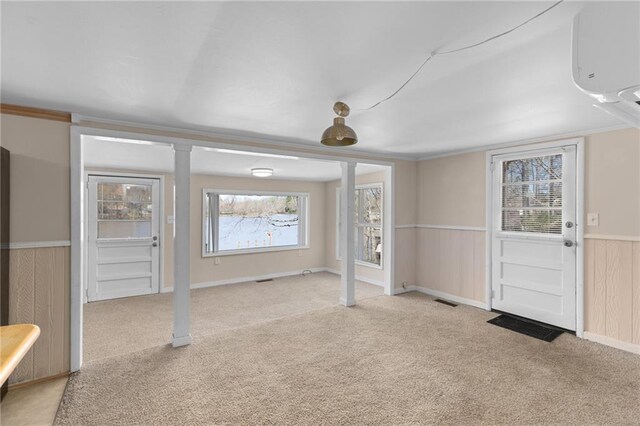 hallway with a water view, baseboards, and light colored carpet
