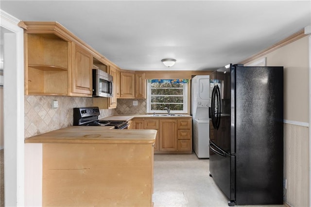 kitchen with light countertops, decorative backsplash, a sink, a peninsula, and black appliances