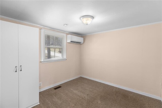 empty room with baseboards, crown molding, and carpet