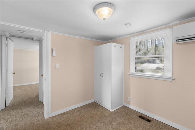 interior space featuring baseboards, ornamental molding, and carpet
