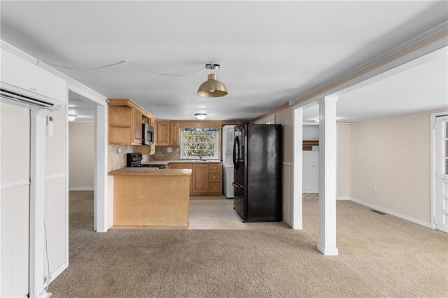spare room with a wainscoted wall, crown molding, carpet floors, a wall unit AC, and visible vents