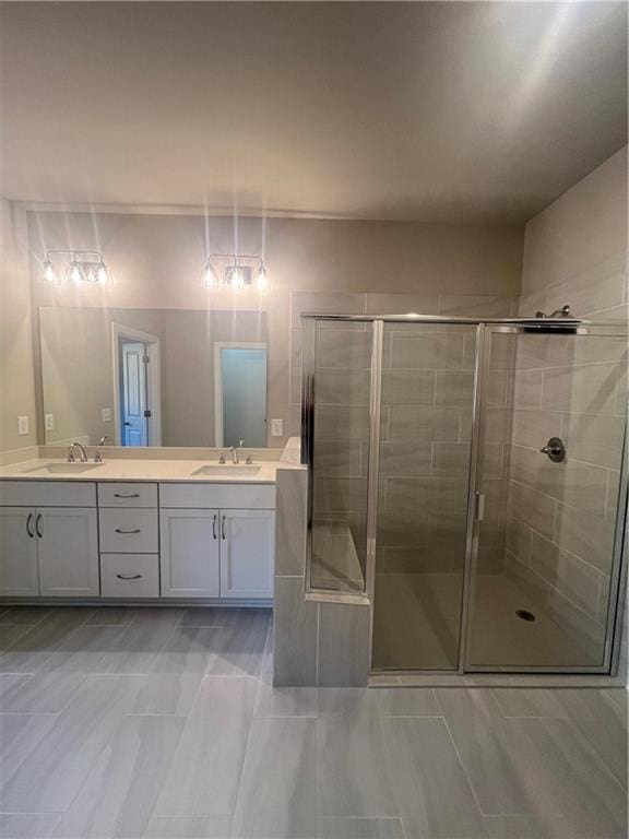 bathroom with vanity and a shower with door