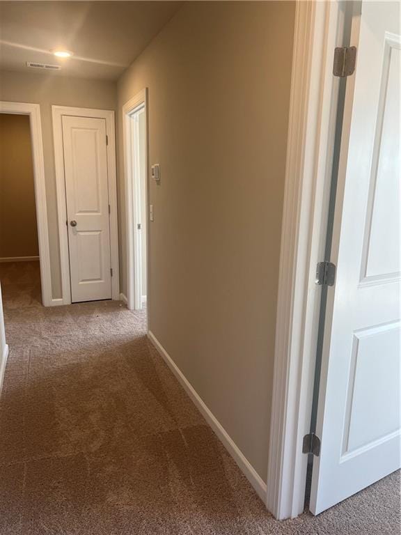 hallway with carpet floors