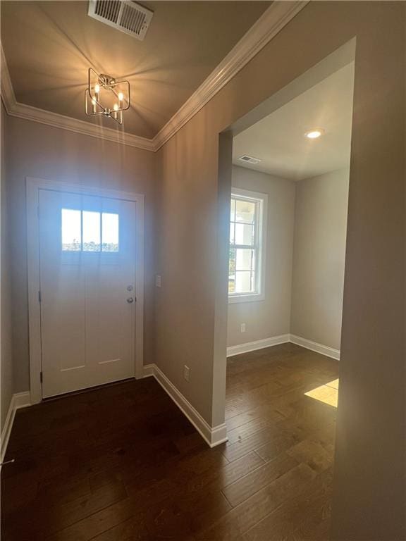 entrance foyer with dark hardwood / wood-style flooring and ornamental molding