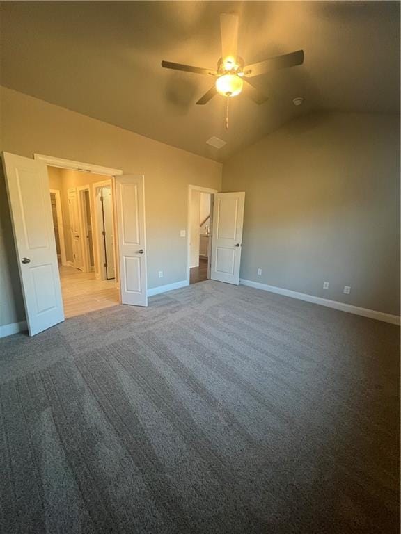 unfurnished bedroom featuring lofted ceiling, carpet floors, and ceiling fan