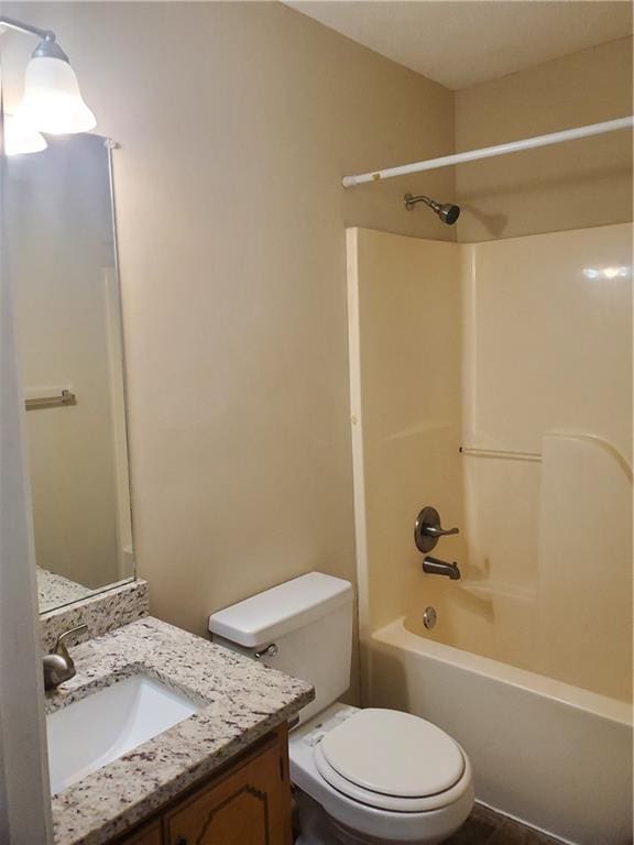 bathroom featuring toilet, shower / bathtub combination, and vanity