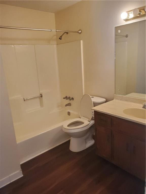 bathroom featuring vanity, shower / washtub combination, wood finished floors, and toilet