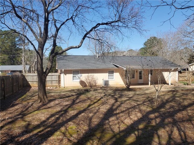 back of house with central air condition unit, fence, and a patio