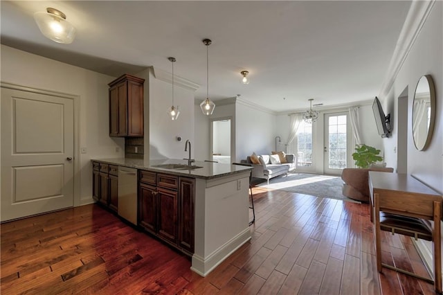 kitchen with sink, dark stone countertops, stainless steel dishwasher, dark hardwood / wood-style flooring, and kitchen peninsula