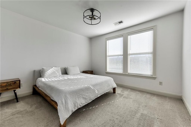 bedroom featuring light colored carpet