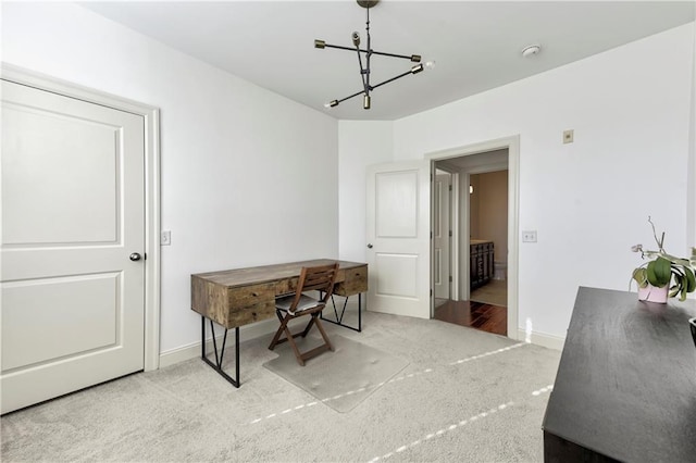 office with light carpet and a notable chandelier