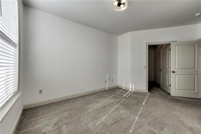 unfurnished bedroom featuring light carpet