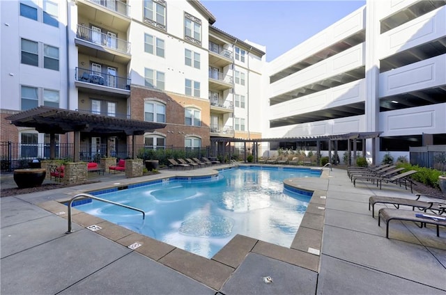 view of swimming pool featuring a pergola and a patio area