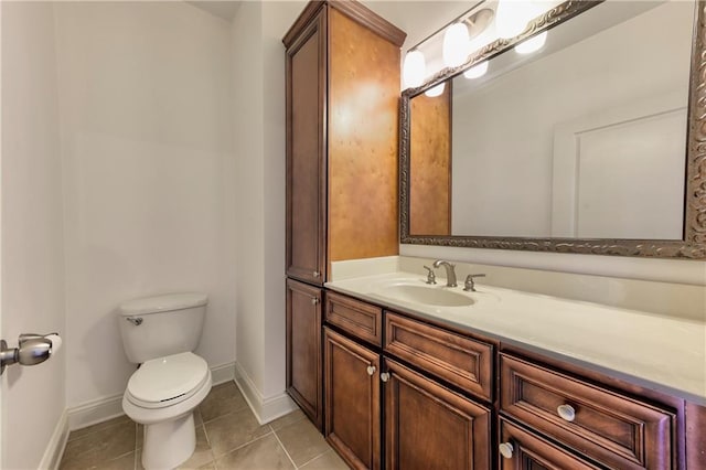 bathroom featuring tile patterned flooring, vanity, and toilet