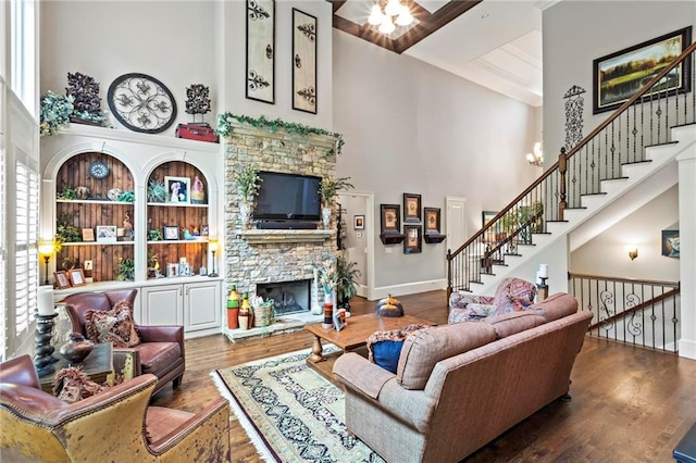 31 Brownson Ct, Acworth, GA 30101 - living room with stairs, a stone fireplace, wood finished floors, and a towering ceiling