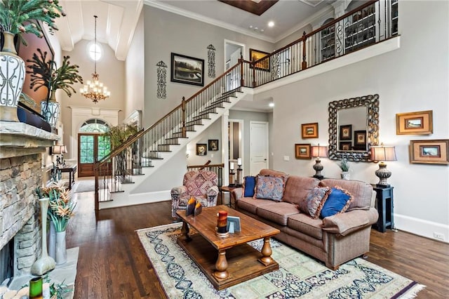 31 Brownson Ct, Acworth, GA 30101 - living area with stairs, a towering ceiling, wood finished floors, baseboards, and a fireplace with raised hearth