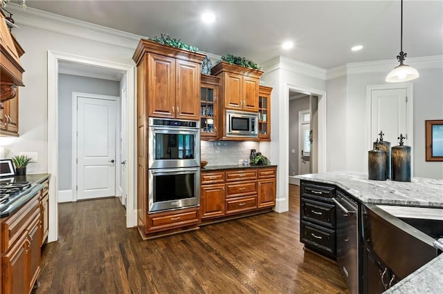 31 Brownson Ct, Acworth, GA 30101 - kitchen featuring pendant lighting, dark wood-style flooring, brown cabinets, light stone counters, and stainless steel appliances
