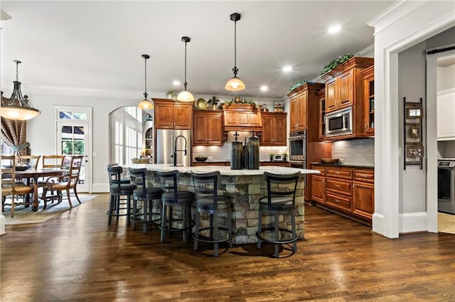 31 Brownson Ct, Acworth, GA 30101 - kitchen featuring decorative backsplash, appliances with stainless steel finishes, a breakfast bar, and a sink