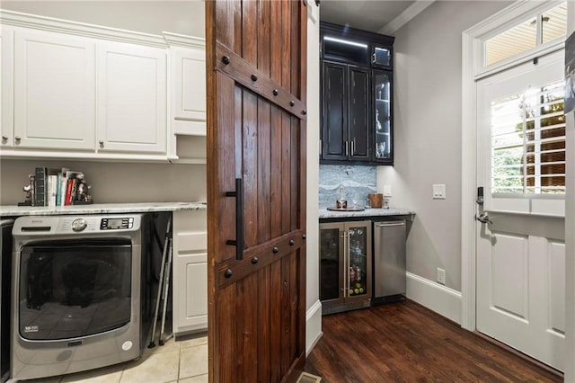 31 Brownson Ct, Acworth, GA 30101 - laundry area featuring light wood-style floors, washer / clothes dryer, cabinet space, a bar, and wine cooler