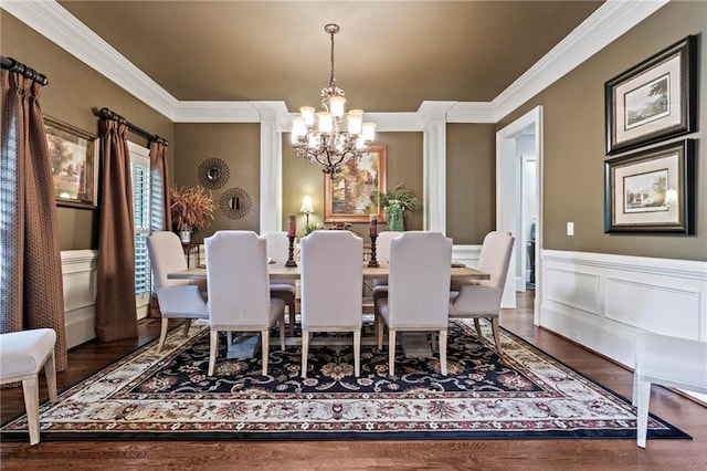31 Brownson Ct, Acworth, GA 30101 - dining room featuring crown molding, an inviting chandelier, a decorative wall, a wainscoted wall, and wood finished floors