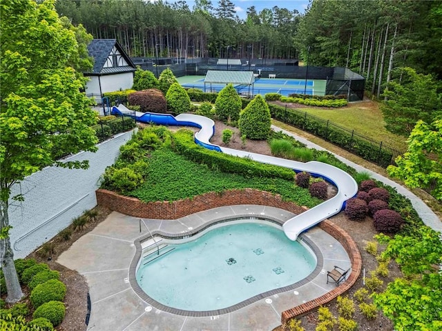 31 Brownson Ct, Acworth, GA 30101 - view of swimming pool featuring fence, a tennis court, a water slide, and a wooded view