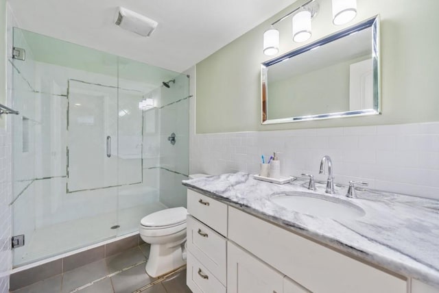 1315 Merry Ln NE, Atlanta, GA 30329 - full bathroom featuring tile walls, a shower stall, vanity, tile patterned floors, and wainscoting