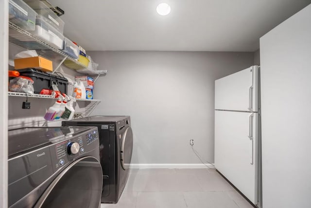 1315 Merry Ln NE, Atlanta, GA 30329 - washroom with washing machine and dryer and light tile patterned floors