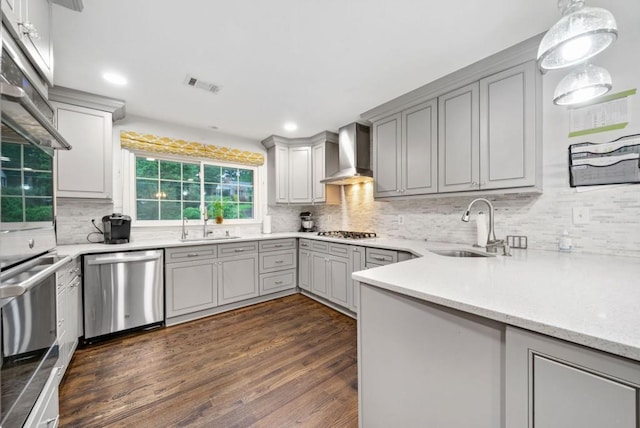 1315 Merry Ln NE, Atlanta, GA 30329 - kitchen with stainless steel dishwasher, wall chimney exhaust hood, gas cooktop, gray cabinetry, and recessed lighting