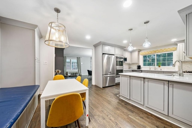 1315 Merry Ln NE, Atlanta, GA 30329 - kitchen with appliances with stainless steel finishes, tasteful backsplash, dark wood-type flooring, recessed lighting, and light countertops