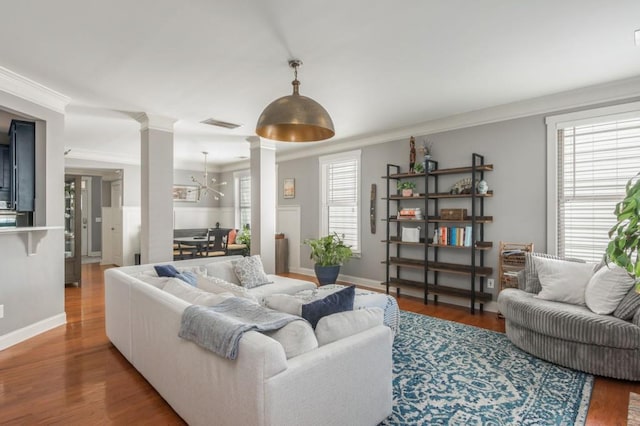 2075 Old Georgian Ter NW, Atlanta, GA 30318 - living area with ornate columns, crown molding, a chandelier, wood finished floors, and baseboards