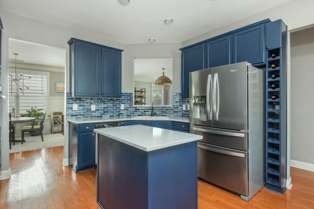 2075 Old Georgian Ter NW, Atlanta, GA 30318 - kitchen with stainless steel fridge, blue cabinets, light wood finished floors, and light countertops