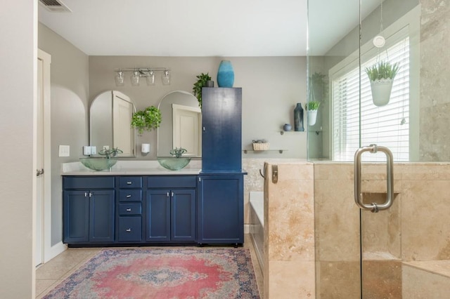 2075 Old Georgian Ter NW, Atlanta, GA 30318 - bathroom with a garden tub, double vanity, tile patterned floors, and an enclosed shower