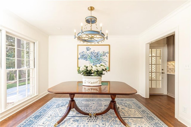 dining room with a healthy amount of sunlight, dark wood-style floors, a chandelier, and crown molding