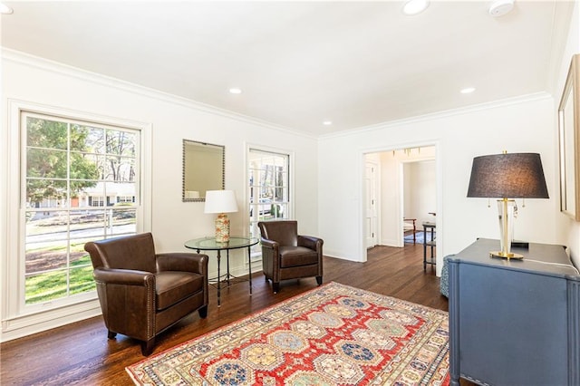 sitting room featuring dark wood-style floors, ornamental molding, and recessed lighting