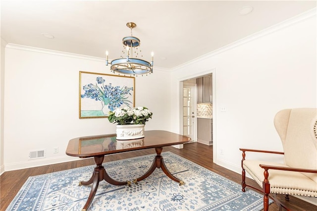 interior space with dark wood finished floors, visible vents, ornamental molding, a chandelier, and baseboards