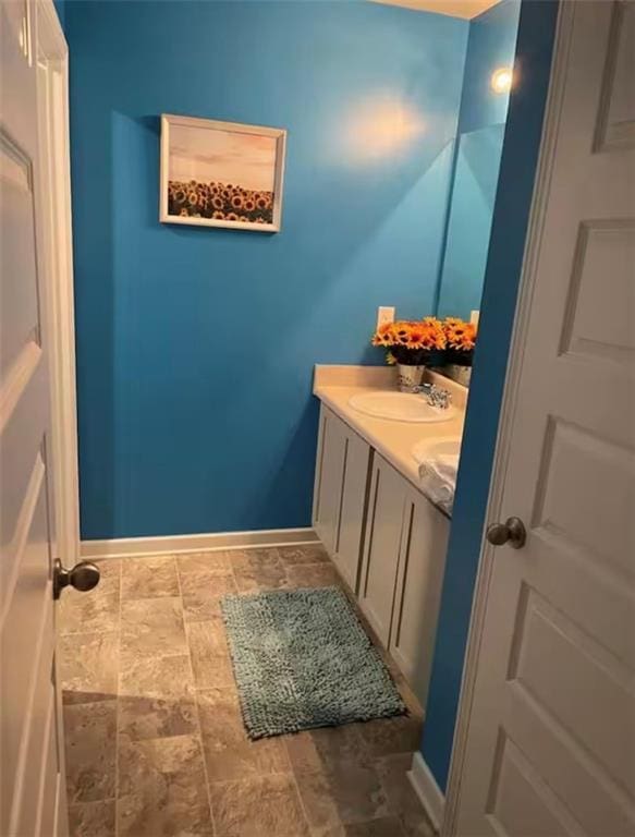 11547 Hathaway Dr, Hampton, GA 30228 - bathroom with vanity and stone finish flooring