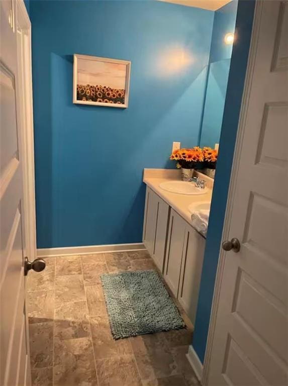 11547 Hathaway Dr, Hampton, GA 30228 - bathroom with double vanity and stone finish floors