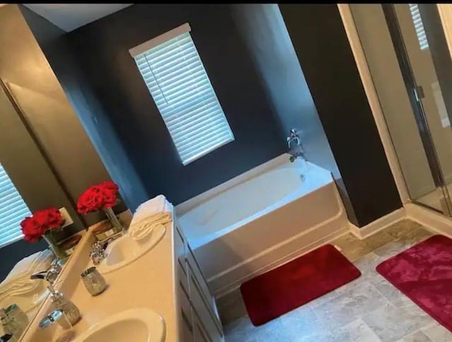 11547 Hathaway Dr, Hampton, GA 30228 - bathroom with a bath, a stall shower, healthy amount of natural light, and double vanity