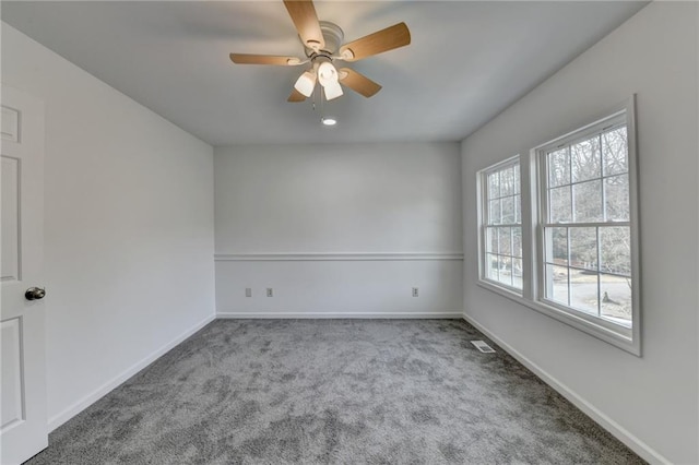 empty room featuring ceiling fan and carpet