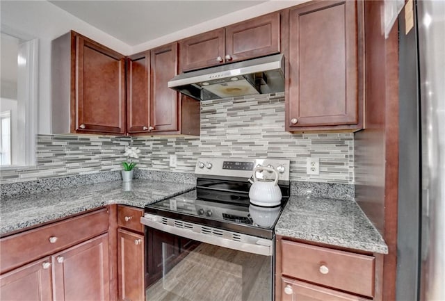 kitchen with stainless steel appliances, light stone countertops, and decorative backsplash