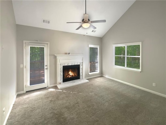 unfurnished living room with lofted ceiling, a premium fireplace, carpet floors, and ceiling fan