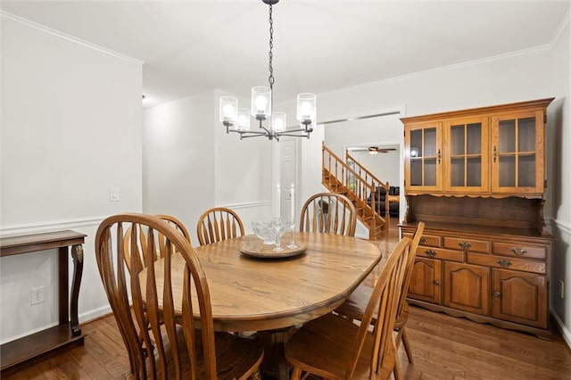 1418 Mill Path Loop, Lawrenceville, GA 30045 - dining space featuring a chandelier, dark wood-style flooring, ceiling fan, crown molding, and stairs