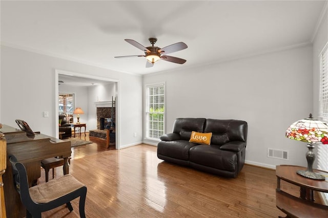 1418 Mill Path Loop, Lawrenceville, GA 30045 - living area with ornamental molding, wood finished floors, a ceiling fan, and a fireplace