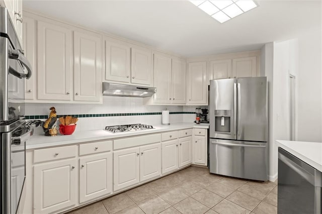 1418 Mill Path Loop, Lawrenceville, GA 30045 - kitchen with stainless steel appliances, under cabinet range hood, light countertops, and light tile patterned floors